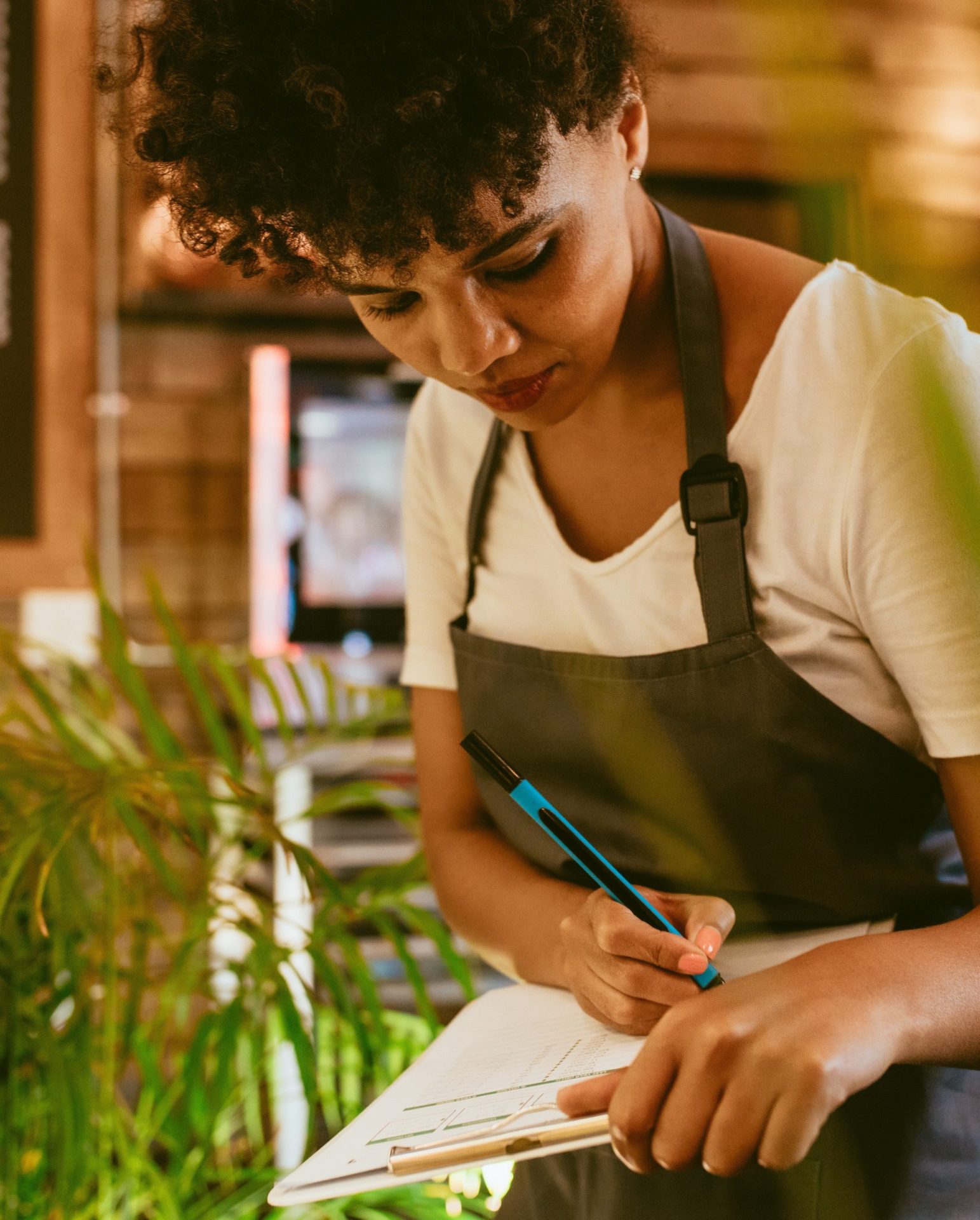 African,Woman,Working,At,Her,Cafe,Checking,Stock,And,Making